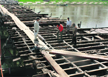 Men at work to strengthen the Zero Bridge in Srinagar