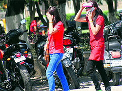 With mercury shooting up in Jammu, venturing out in the sun is a no-no. University students try to protect themselves from the scorching sun in Jammu