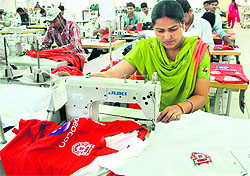 Workers stitch jerseys for Kings XI Punjab team in Jalandhar on Thursday