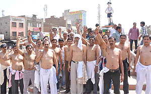 Goldsmiths hold a semi-nude procession to resent the increase in excise duty on gold on Friday