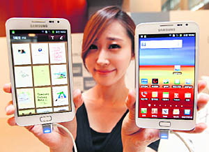 A model poses with Galaxy Note of Samsung Electronics at the company's headquarters in Seoul. Samsung has sold 5 million of the phone/tablet Galaxy Note, helping drive its booming handset profits in the quarter just ended. Samsung Electronics posted record quarterly profit of $5.15 billion, driven by booming sales of its smartphones and the Galaxy Note 'phablet', which it hopes will show it has a flair for innovation to match rival Apple Inc.