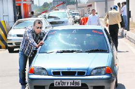 A man pushes his car after it broke down.
