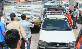 A truck and a car that collided during a traffic jam at the toll plaza.