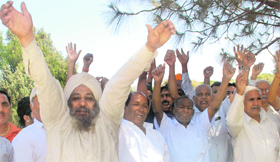 Members of depot holder joint action committee protest at Phase IIIB-1 in Mohali on Friday.