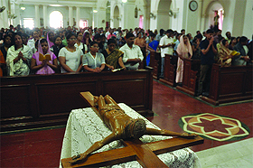 Christian devotees offer prayers on Good Friday at a church near Gole Dak Khana in New Delhi. 