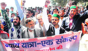 People of Theog and Kumarsain raise slogans in support of their demands outside the Vidhan Sabha in Shimla on Friday.