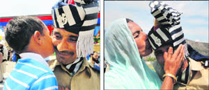 A son hugs his father; a mother blesses her son after the parade.