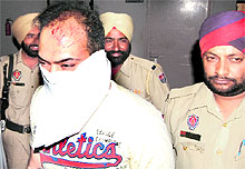 Accused Gur Iqbal Singh in police custody in Jalandhar on Friday