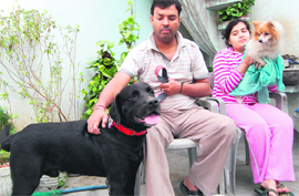 A family enjoys time with their pets at their home in Amritsar.