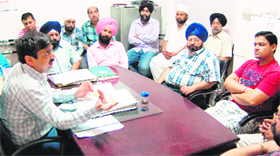 Health officer of the MC Dr Yogesh Arora holds a meeting with the traders in Amritsar on Saturday.