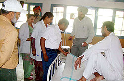 Deputy Commissioner S Karuna Raju interacts with the patients during a surprise visit to the Civil Hospital in Ferozepur on Saturday