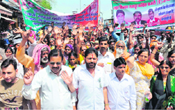 Slum dwellers hold a march to the Irrigation Departments office in Haridwar 