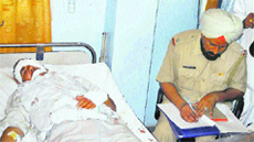 A policeman takes the statement of an injured passenger in the mishap near Badopal village at a hospital in Hisar on Saturday.
