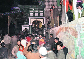 Devotees throng the shrine of Khwaja Zain-u-Din Wali at Aishmuqam in south Kashmir on the annual Urs on Saturday. 