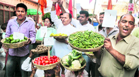 Shiv Sena activists stage a protest against the increase in vegetable prices in Jammu on Saturday.