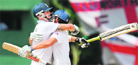 Englands Kevin Pietersen (L) and Alastair Cook celebrate their teams victory on the final day of the second Test against Sri Lanka at the P. Sara Oval cricket Stadium in Colombo on Saturday.