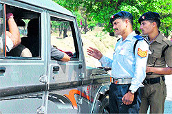 Traffic policemen intercept a vehicle in Haridwar on Sunday