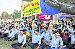 Striking workers of Rockman factory, Haridwar, stage a dharna in support of their demands at Parade Ground in Dehradun on Sunday