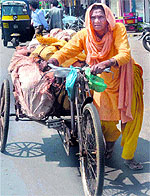 A 70-year-old woman pulls a rickshaw carrying earthen pots in the scorching heat to earn livelihood in Haridwar on Sunday