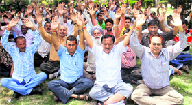 Members of the National Mazdoor Conference protest at Rani park in Jammu on Sunday.