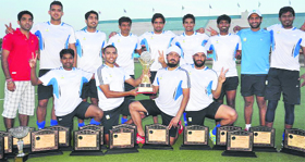 The winners pose with the trophy at Olympian Surjit Hockey Stadium in Jalandhar on Sunday.