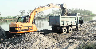 A JCB machine in action at Saidpur Kanon village in Ludhiana district.