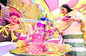 A woman showcases chocolates and packaging boxes at an exhibition in Ludhiana on Sunday.