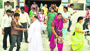 Devotees come out of a church after offering prayers on the occasion of Easter in Ludhiana on Sunday.
