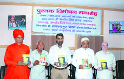 Kurukshetra Deputy Commissioner Mandip Singh Brar (third from left) releases two Hindi books by Dr RB Langyan (second from left) at Kurukshetra.