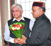 Chief Minister Prem Kumar Dhumal greets Union Minister of State for Planning Ashwani Kumar in Shimla on Monday.