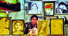 Khushdeep Kaur, an artist with a passion for sketching portraits, with her works at an exhibition in Ludhiana.