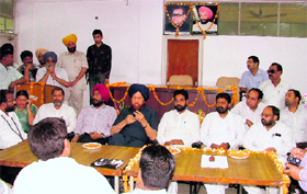 A function under way at the Zone A office of the MC in Ludhiana on Monday. The seating arrangement was changed following insistance of leaders. Earlier, on the two chairs at the dais in the background the Mayor and the MC Commissioner were to sit.