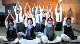 Children perform yoga at a school in Ludhiana.
