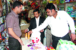 The team designated by Patiala House court in Delhi conducts a raid at a shop in Mehna Chowk to check for fake Garnier products