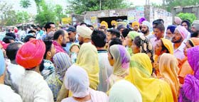Villagers argue with a police official on the Banur-Landran highway on Tuesday