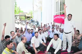 Members of the Uttarakhand Audit Joint Employees Organisation hold a dharna in support of their demands in Dehradun on Tuesday