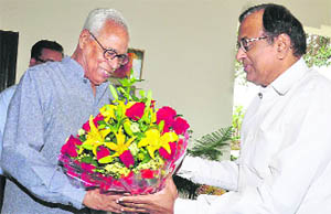 Governor NN Vohra presents a bouquet to Union Home Minister P Chidambaram at Raj Bhawan in Jammu on Tuesday.