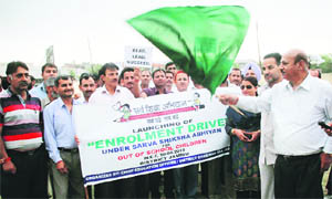 Chief Education Officer NR Dhingra and District Chairman Sarv Shiksha Abhiyan flag off a rally of   teachers in Jammu on Tuesday. 