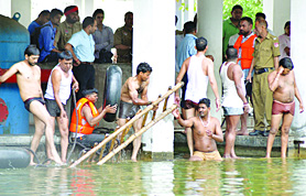 A rescue operation in progress at Devi Talaab Mandir where a middle-aged man committed suicide in Jalandhar on Tuesday.