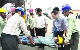 A team of doctors from the Civil Hospital with an injured person during a mock drill held at the Indane bottling plant at Suchi Pind in Jalandhar on Tuesday.