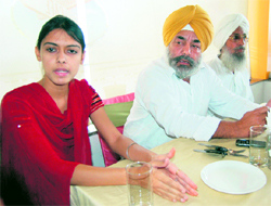 Congress rebel Sukhjinder Raj Singh Majithia along with Harleen Kaur addresses mediapersons in Amritsar on Wednesday.
