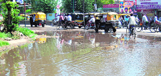 Residents face commuting woes as water accumulates on a road after a heavy rain on Tuesday night in Amritsar.