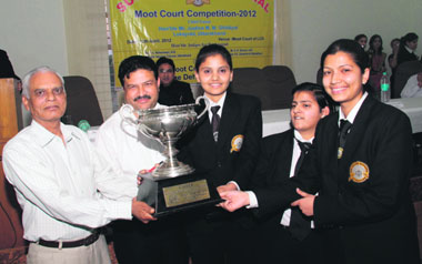Justice MM Ghildiyal (retd), Lokayukta, Uttarakhand, gives away the winning trophy of the Third Sushila Devi Memorial Moot Court Competition to the winners in Dehradun on Wednesday.