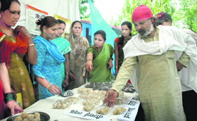 Women have a look at various products on display at a mela in Shuklapur village near Dehradun on Wednesday.