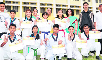 Tae kwon do players of Gayatri Vidyapeeth with their medals and certificates in Haridwar on Wednesday. 