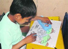 A student draws on a sheet during a painting competition held by the Army in Rajouri on Wednesday.