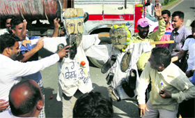 BSP workers throw tomatoes and eggs on the effigies of party leaders Narinder Kashyap and Avtar Singh Karimpuri in Jalandhar on Wednesday.