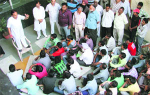 A group of sewer men discuss their issues at the MC Zone D office in Ludhiana on Wednesday. 