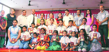 Students strike a pose with their trophies at the prize distribution function at Sanatan Vidya Mandir Senior Secondary School in Ludhiana.
