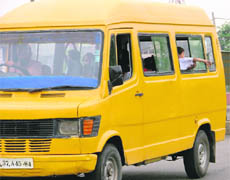 In the absence of a safety grill, a student puts his life in danger by swinging his arm outside the window of his school van in Ludhiana.